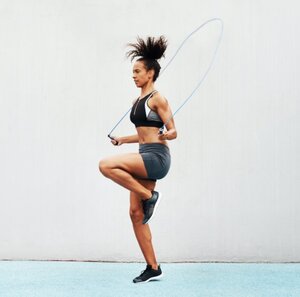 Woman jump roping for fitness training